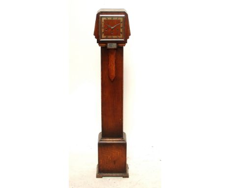 A 1930s Art Deco style oak cased eight day chiming grandmother clock, the rectangular dial set with Roman numerals to chapter