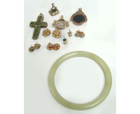 A pair of 9ct gold floral set earrings, a further pair of green peridot set earrings, three fobs, a pair of ear clips, a cros