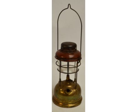An early brass and enamelled Tilley lamp with swing loop handle and domed base inscribed "Tilley-England", height 35cm.