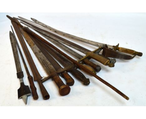 A quantity of decorative swords including examples with wooden handles, horn handles, etc, also a blade form a late 19th cent