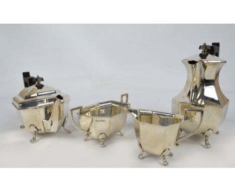 A George VI hallmarked silver four piece tea service of oval octagonal form, comprising a teapot, baluster hot water jug, twi