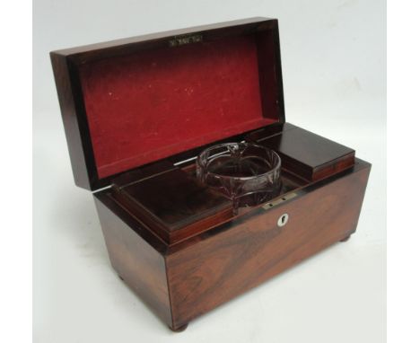 An early Victorian rosewood tea caddy of sarcophagus form, with central glass section (cover missing), flanked by two lidded 