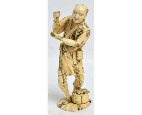 A large Japanese Meiji period ivory sectional okimono depicting a farmer with basket of fruit at his feet, signed to base, he