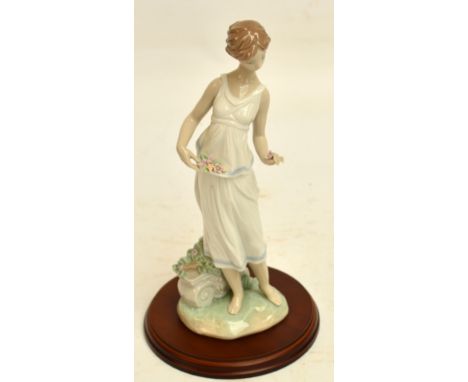 A boxed Lladro figure; 7709 "Flowers for a Goddess", with stand. CONDITION REPORT: Appears good with no obvious signs of faul