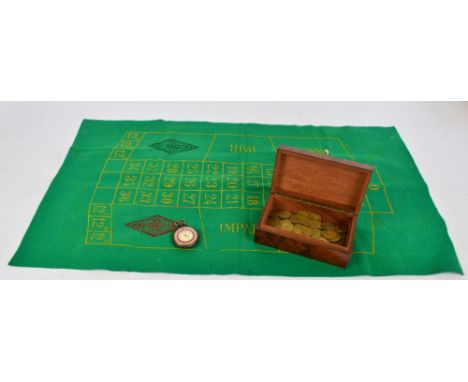A vintage roulette set comprising an early 20th century "Monaco Roulette" stopwatch, a green felt playing surface with markin
