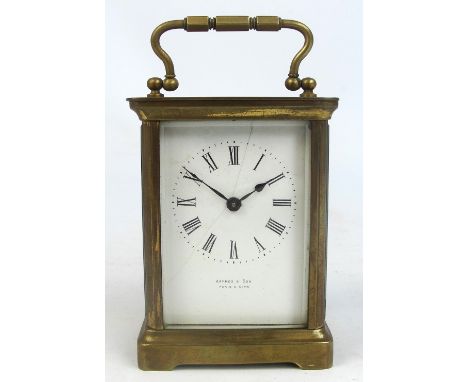A late 19th century French brass cased carriage clock with white enamel dial set with Roman numerals inscribed "Haynes & Son,