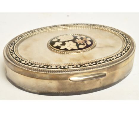 A modern white metal Indian oval trinket box with floral decoration, marked to base "S.T.SILVER", width 18cm, in presentation
