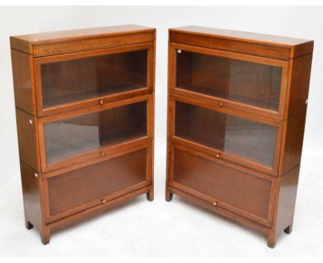 A pair of oak Globe Wernicke style bookcases with two glazed shelves above one enclosed, width of each 87cm.