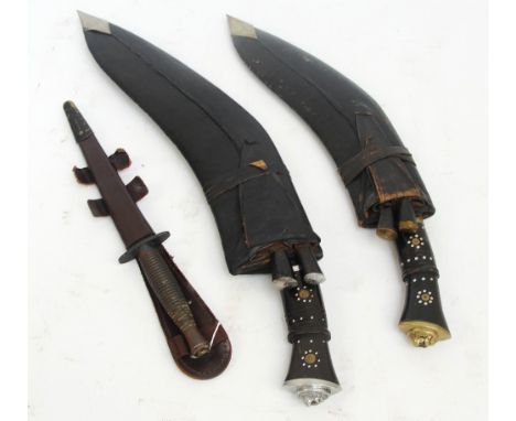 A kukri knife with horn handle and leather scabbard containing two smaller knives, length 51.5cm and a smaller example, lengt