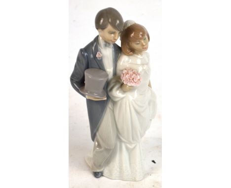 A Lladro figure group of a bride and groom, height 21.5cm.