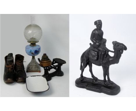 An oil lamp with blue painted glass reservoir on tapering square foot, a pair of leather metal bound clogs, a wrought iron do