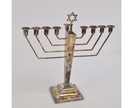 An Elizabeth II hallmarked silver Art Deco style Menorah candelabrum, the square tapering stem surmounted with star of David 