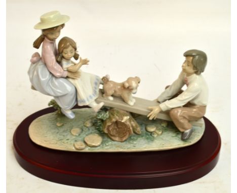 A boxed Lladro figure group; 06169 "Seesaw Friends", width 28cm, with stand. CONDITION REPORT: Appears good with no obvious s