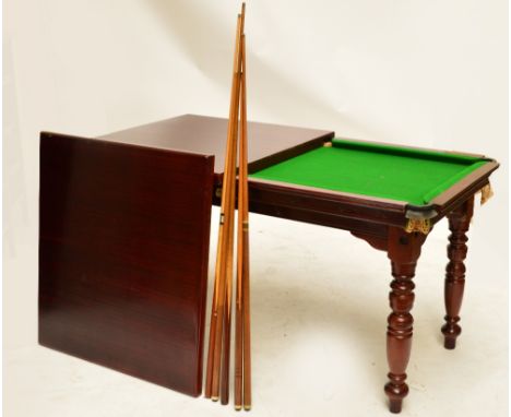 A modern mahogany dining/snooker table, on four ring turned supports, top 170 x 94cm, height 85cm, with accessories.