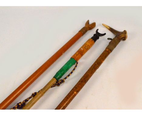 Three wading staffs/walking sticks, two with thumb stick ends and one with an antler type handle, longest 140cm.