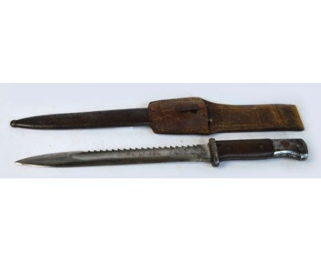 A WWI saw back bayonet, the blade stamped "Erfurt", with metal scabbard and leather belt attachment, length 41cm.