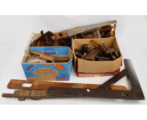 A quantity of tools including a brass mounted buck plane, a rosewood and brass mounted plane, a large square, a level, more p