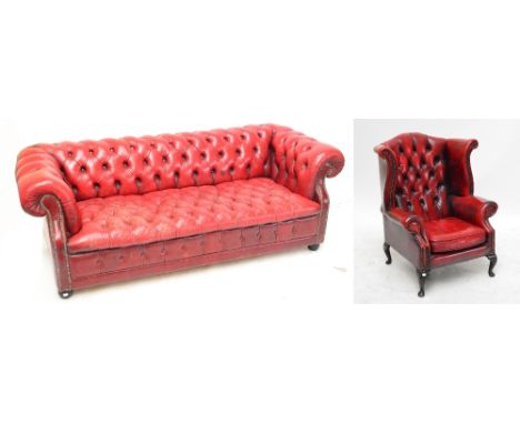 Two red leather button upholstered Chesterfield settees and a matching wingback armchair raised on cabriole front legs (3).