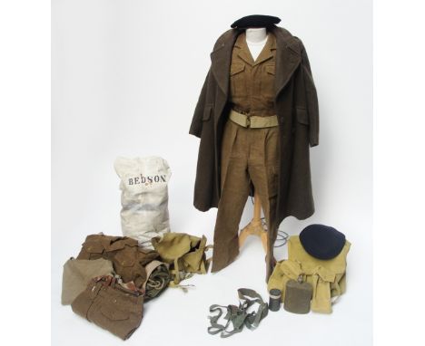 A complete British Army uniform for the Intelligence Corps including greatcoat, two jackets, two pairs of trousers, jumper, w