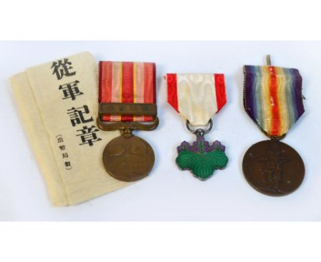 A WWI Japanese Allied Victory medal with ribbon, a WWII Japanese War medal in box, and a Japanese Order of the Rising Sun ena