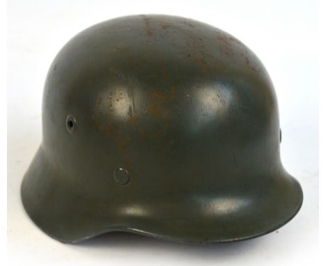 A German M42 helmet (lacking decals and possibly later lined).