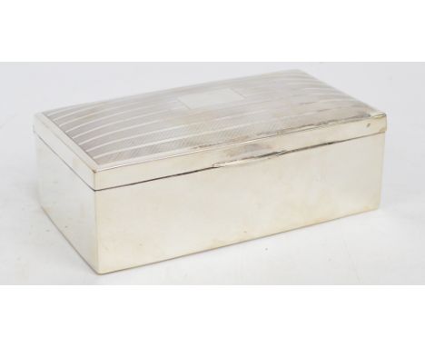 A George V hallmarked silver cigarette box, the hinged engine turn decorated lid with central plaque bearing traces of inscri