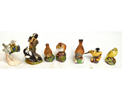 Six Royal Worcester matt glazed figures of birds; "Hedge Sparrow", "Nightingale", "Pied Woodpeckers", "Wood Warbler", "Marsh 