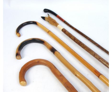 A collection of sticks including a deer foot slot thumb stick, an example with lacquered and painted decoration, one with imp