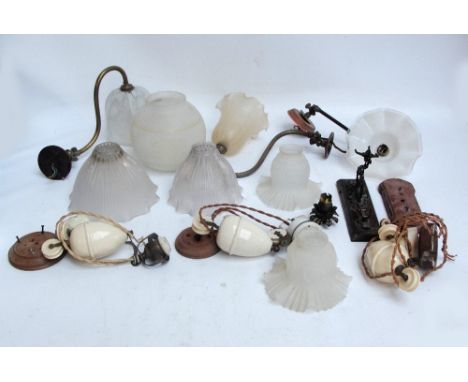 Three late 19th century brass single branch wall mounted lights with shaped shades, five various assorted additional shades, 