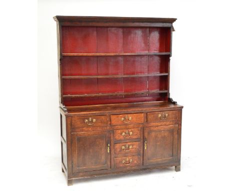 An early 19th century North Walian dresser with three shelf plate rack and base with T-formation of drawers and two cupboard 