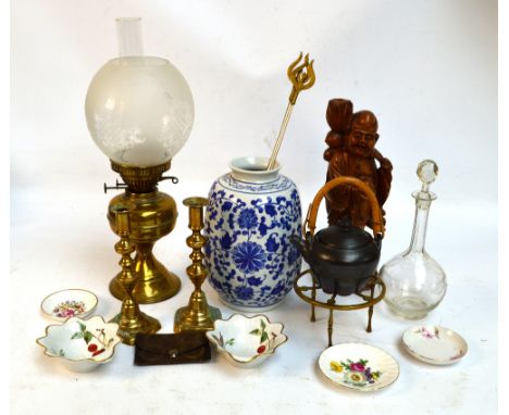 A brass oil lamp with globular frosted glass shade, a pair of brass candlesticks, a kettle stove, a crescent shaped ashtray, 