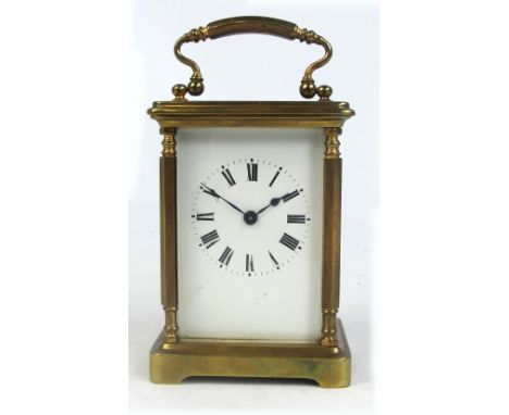 A late 19th century French brass cased carriage clock with a rectangular enamel dial set with Roman numerals flanked by pilas