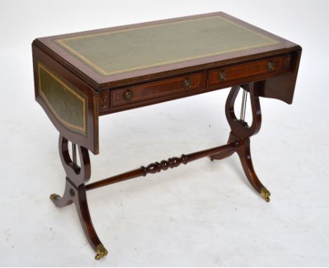 A reproduction gilt tooled leather lined sofa table with two frieze drawers above lyre shaped stretcher supports, width 93cm.