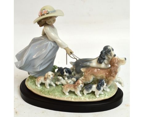 A boxed Lladro figure group; 06784 "Puppy Parade", width 30cm, with stand. CONDITION REPORT: Appears good with no obvious sig