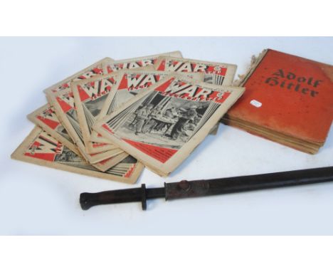 A WWI bayonet in leather scabbard, length 57cm, a quantity of War Illustrated magazines, and a commemorative book relating to