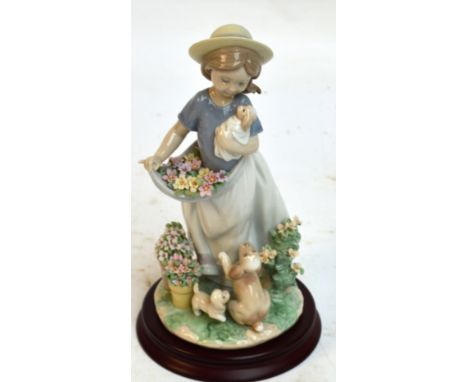 A boxed Lladro figure group; 6907 "A Romp in The Garden", with stand. CONDITION REPORT: Appears good with no obvious signs of