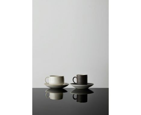 [§] LUCIE RIE D.B.E. (BRITISH, 1902-1995)TWO TEA CUPS AND SAUCERS each impressed artist's seal, one in white glaze with manga