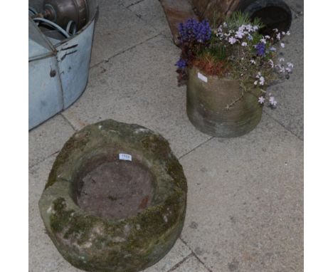 A small stone trough and a cylindrical planter 