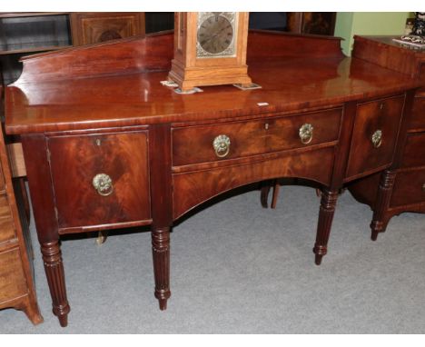 Early 19th century mahogany bow fronted sideboard on turned and reeded legs, 183cm wide 