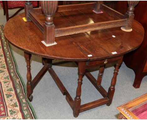 An early 18th century gate leg dining table with spindle legs 