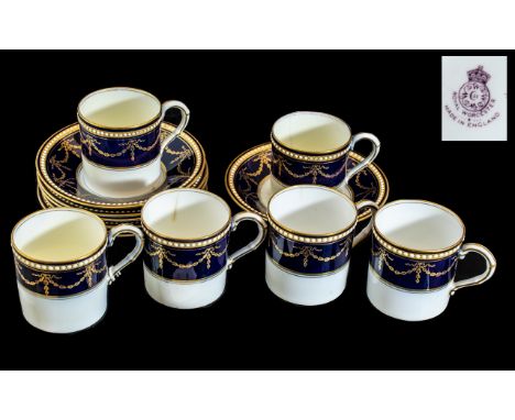Royal Worcester Set of Six Coffee Cans and Saucers, in white ground with dark blue and gilt garland decoration,