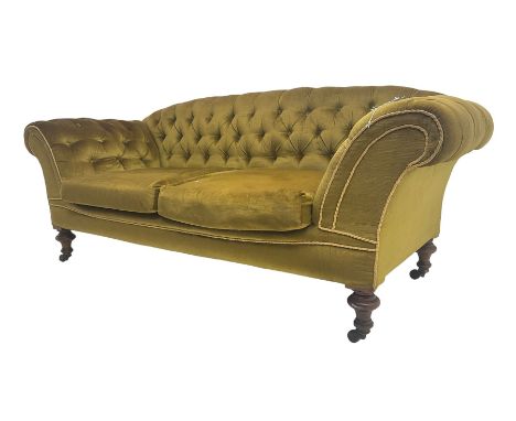 Victorian walnut framed two seat sofa, upholstered in buttoned  olive green fabric with sprung seat and scrolled arms, raised