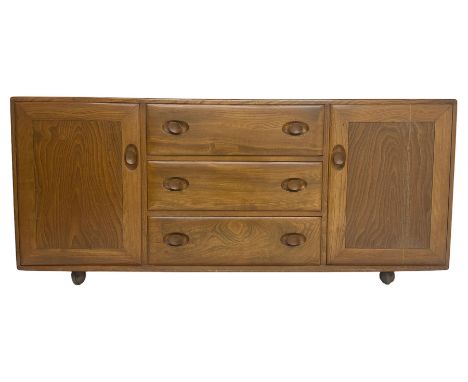 Ercol - mid-20th century blonde elm 'Windsor' sideboard, fitted with three drawers flanked two cupboards, on castorsDimension