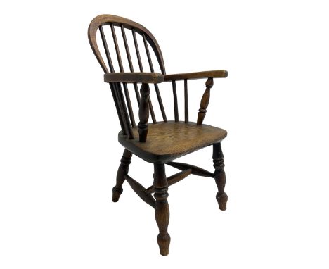 Childs Windsor elm and ash armchair, the double hooped and spindle back over saddle seat, raised on ring turned supports unit