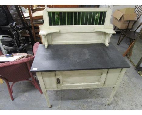 A white painted early 20th century wash stand with extended tile back with secessionist style decoration, black slate top ove