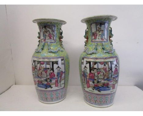 A pair of late 19th century Chinese Canton porcelain vases of baluster form, with flared necks, decorated with panels of warr