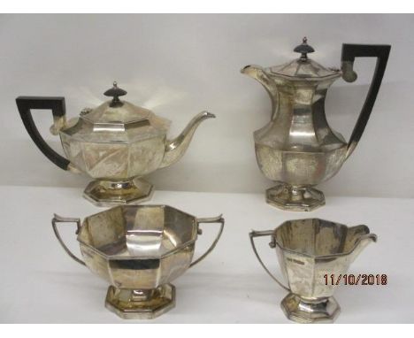 A silver four piece tea set by Walker and Hall, Sheffield 1939 of octagonal, pedestal form, comprising a teapot, a hot water 