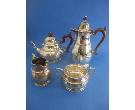 A 1920s matched four piece silver tea set by Adie Brothers, Birmingham and London 1923, of baluster form with banded decorati