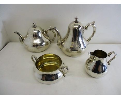 A mid Victorian silver four piece tea set by Robert Garrard II, London 1865 of domed, bulbous form with a cast knopped finial