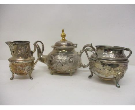 A modern silver coloured metal matched three piece teaset, embossed and chased with flowers and swags, comprising a teapot, a